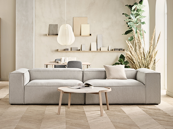 Couch in qual grey, and a Bolia mix coffee table with oak features