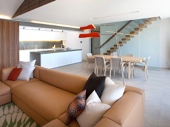 David Weeks studio Torroja lamp, with 2 arms over an angular base above a brown couch