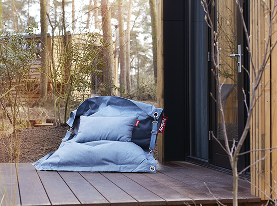 Fatboy buggle up outdoor beanbag, in a mineral blue color with corner straps and matching blue pillow