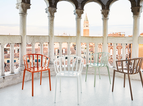 Kartell Venice, polycarbonate plastic slotted chairs, in various colors, on a balcony in Venice