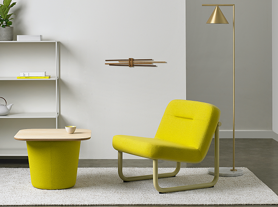 Vibrant white room with a, Memo chroma lounge chair, next to a cone shaped ottoman in a highlighter yellow finish