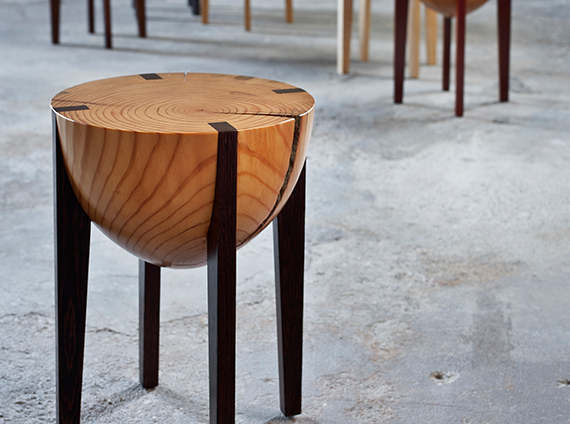 Miles and May wood stool with dark colored legs and top with a rounded bottom