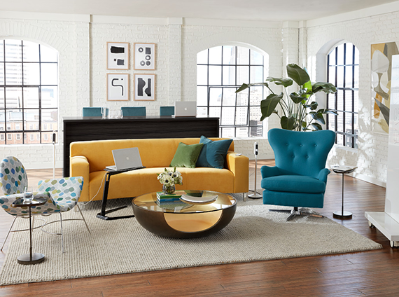 Living room with a Mitchell Gold + Bob Williams sofa, swivel lounge chair and a curved spotted chair, all in various light colors