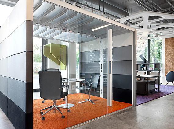 Orangebox air 3, acoustic meeting room with chairs, conference table, a TV and orange carpet