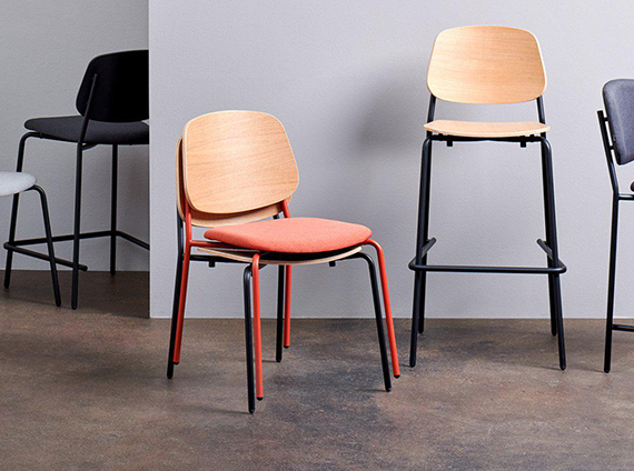 Multiple mad branded dining chairs, in various heights and colored fabric with wood finished back rests