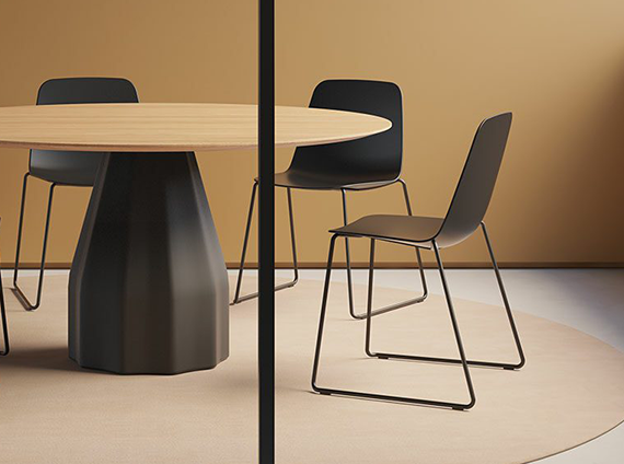 Unique black polyethylene based table, with a wood top and black steel framed chairs